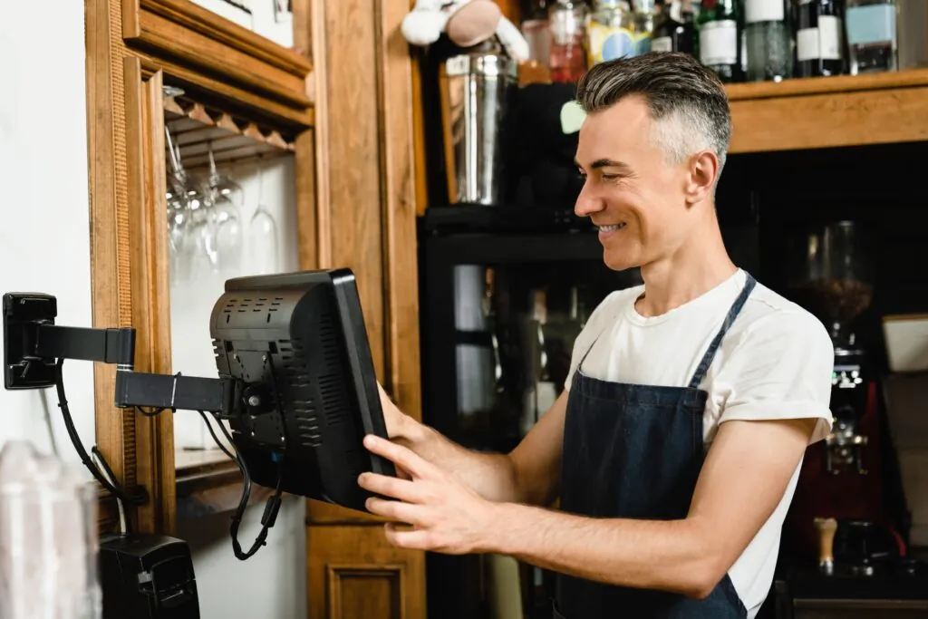 Caucasian Mature Male Waiter, Barista, Bartender, Small Business Owner in blue apron